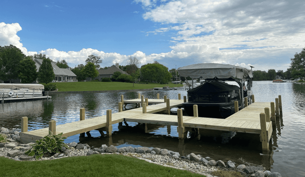 Large custom wood dock on Upper Oconomowoc Lake, custom built for easy boat slip access.
