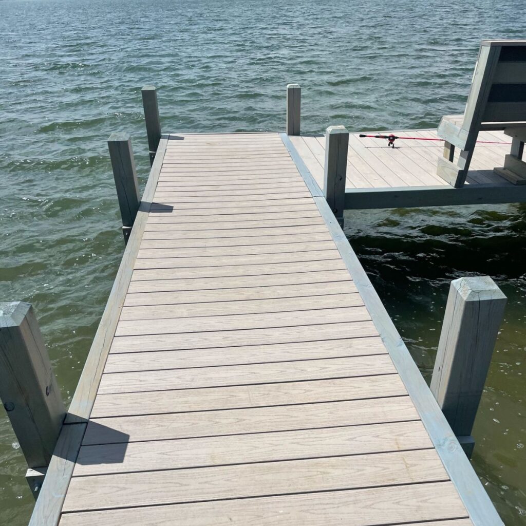 Stained wood dock on Pewaukee Lake built by Rock Docks in Wisconsin