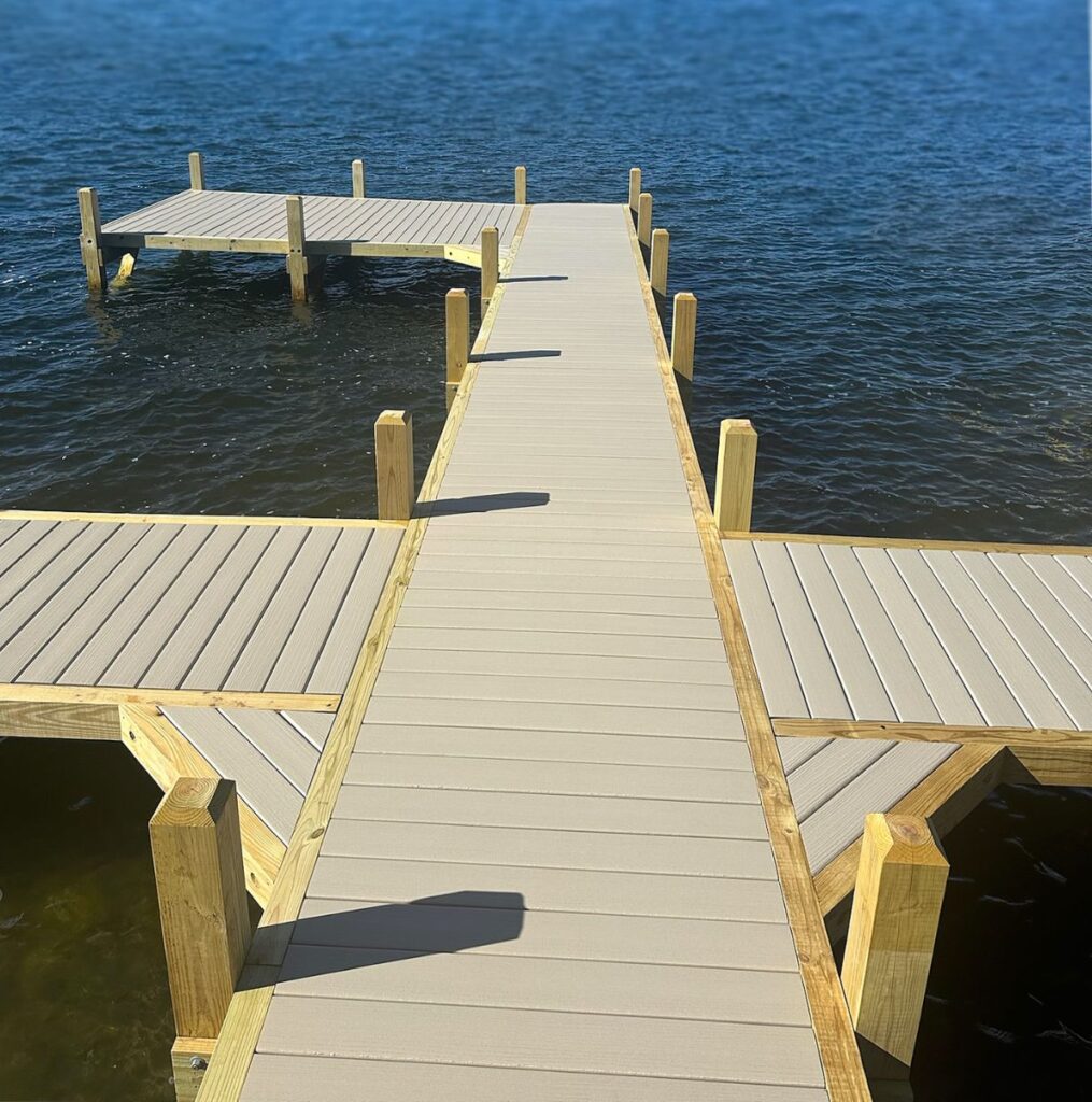 Large custom wood pier on Pewaukee Lake with boat slips, jet ski parking, and sun deck built by Rock Docks